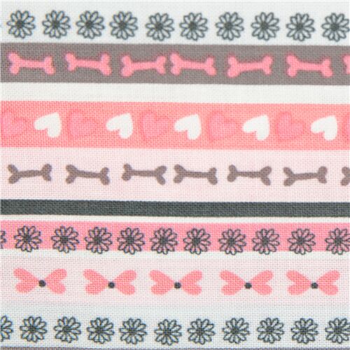 Tissu en coton rose avec des rangées d'os, de fleurs, de coeurs Tissu